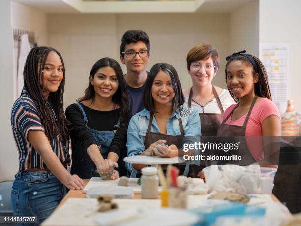 latin group of young people smiling at the camera - art class stock pictures, royalty-free photos & images