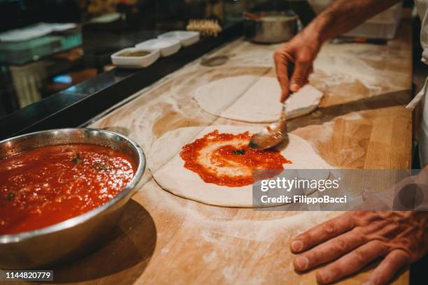 pizza chef preparing a pizza at the restaurant - kneading stock pictures, royalty-free photos & images