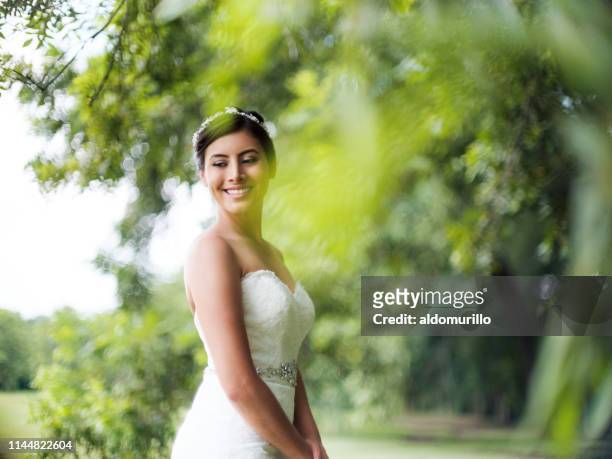 Beautiful bride standing outdoors and smiling