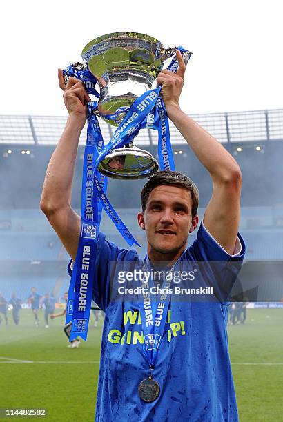 John Main of AFC Wimbledon celebrates with the Blue Square Bet Premier League Play Off Trophy following the Blue Square Bet Premier League Play Off...