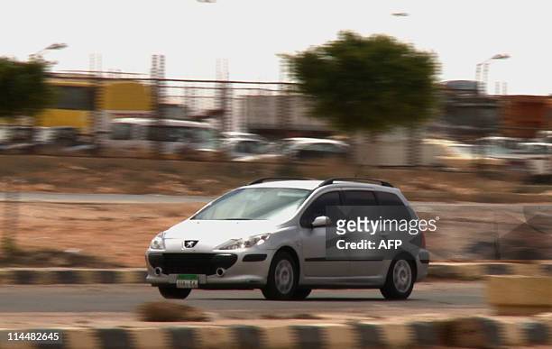 Vehicle sporting an Egyptian diplomatic number plate, is seen driving away from the Sallum border crossing with Libya into Egypt on May 21, 2011....