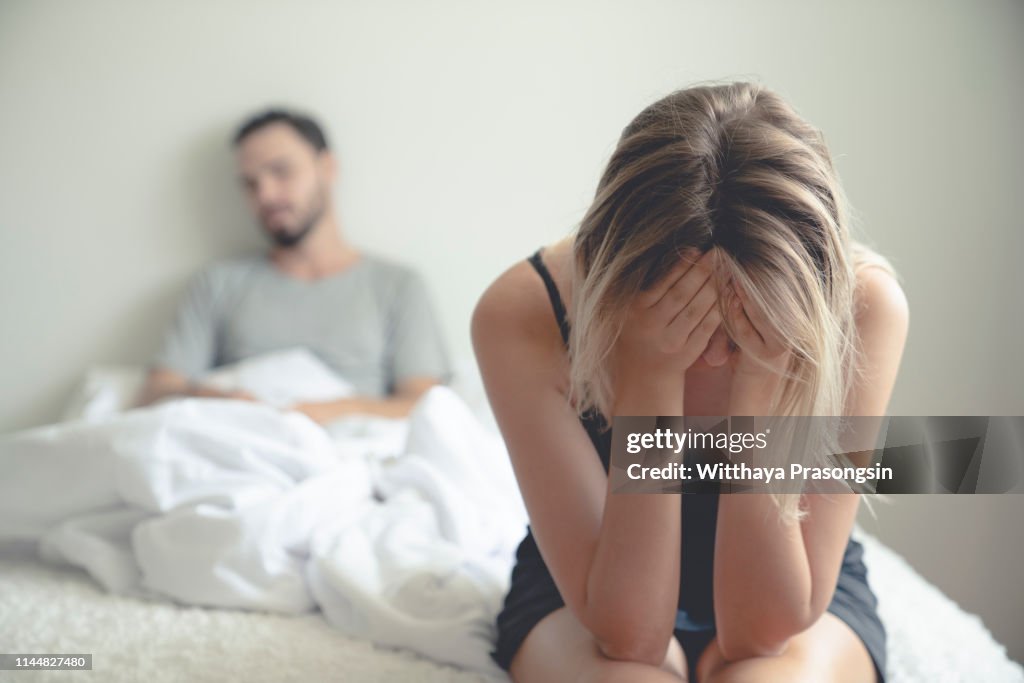 Frustrated sad girlfriend sit on bed think of relationship problems