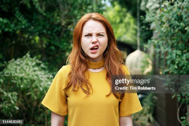 woman pulling face - funny face woman stock-fotos und bilder
