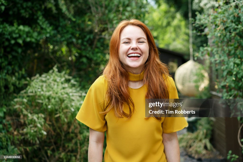 Woman laughing, looking at camera