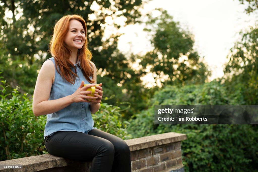 Woman relaxing with mug of tea