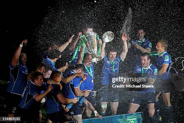 Brian O'Driscoll of Leinster and his team mates celebrate victory with the trophy and champagne at the end of the Heineken Cup Final match between...