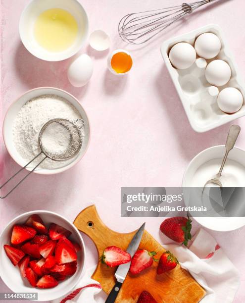 baking ingredients for making strawberry cake or pie - egg white background stock-fotos und bilder