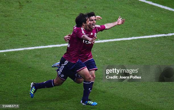 Jose Manuel Jurado Marin of Schalke celebrates with his team mate Raul after scoring his team's fourth goal during the DFB Cup final match between...