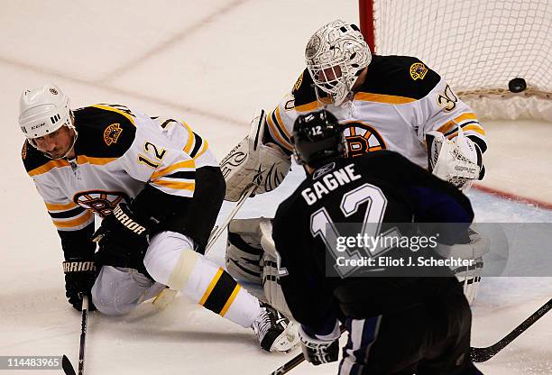 Simon Gagne of the Tampa Bay Lightning scores a third period goal past Tomas Kaberle and Tim Thomas of the Boston Bruins in Game Four of the Eastern...