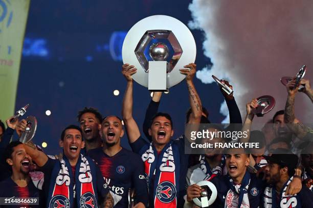 Paris Saint-Germain's Brazilian defender Thiago Silva celebrates with the champion's trophy at the end of the French L1 football match between Paris...