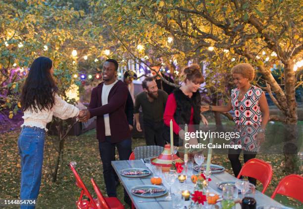 friends talking at dinner garden party - fall party arrivals ストックフォトと画像