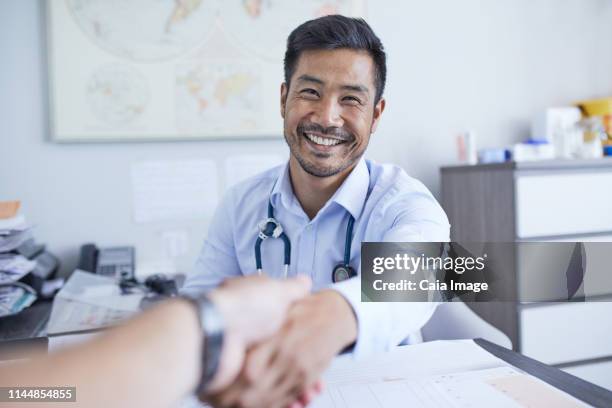 point of view happy doctor shaking hands with patient - personal perspective doctor stock pictures, royalty-free photos & images