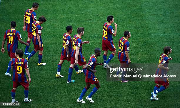 Players of Barcelona walk after the celebrate the fisrt goal during the La Liga match between Malaga and Barcelona at La Rosaleda Stadium on May 21,...