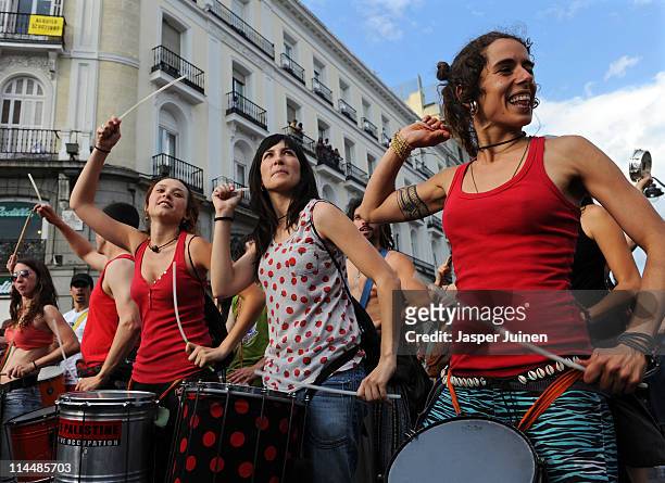 Demonstrators dance while playing their drums at Sol Square on May 21, 2011 in Madrid, Spain. A growing number of angry Spaniards have, encouraged by...