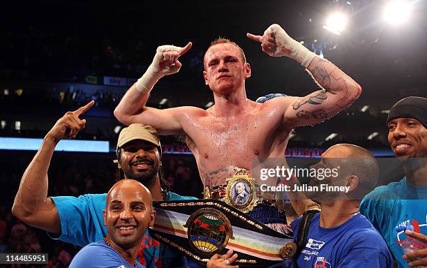 George Groves of England celebrates defeating James DeGale of England with David Haye in the British and Commonwealth Super-Middleweight Championship...