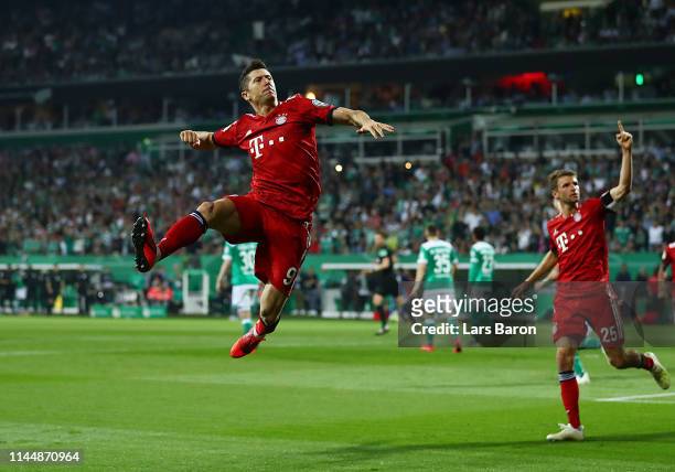 Robert Lewandowski of FC Bayern Muenchen celebrates after scoring his team's third goal during the DFB Cup semi final match between Werder Bremen and...