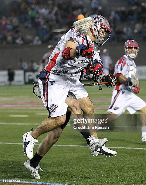 Jon Hayes of the Boston Cannons is defended by Steve Giannone of the Denver Outlaws at Harvard Stadium on May 21, 2011 in Boston, Massachusetts.