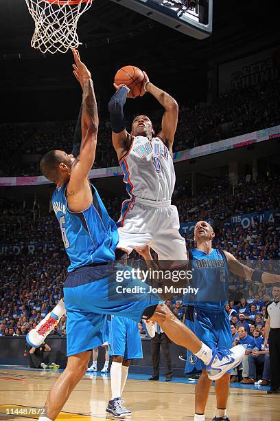 Russell Westbrook of the Oklahoma City Thunder shoots against Tyson Chandler of the Dallas Mavericks during Game Three of the Western Conference...