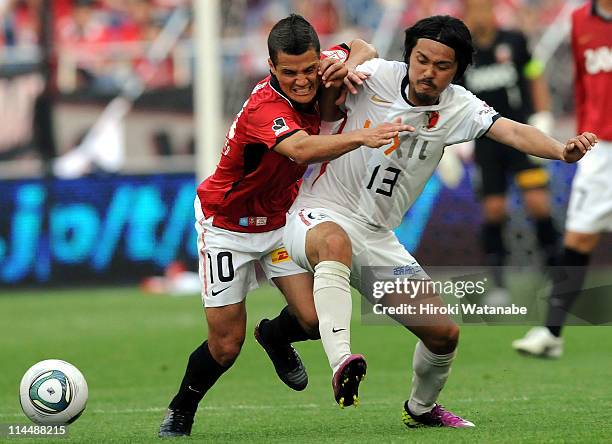 Marcio Richardes of Urawa Red Diamonds and Shinzo Koroki of Kashima Antlers compete for the ball during J.League match between Urawa Red Diamonds and...