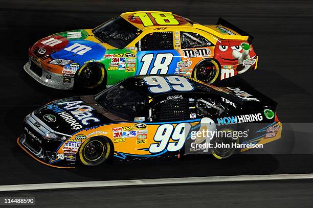 Carl Edwards, driver of the Aflac Ford, races Kyle Busch, driver of the M&M's Toyota, during the NASCAR Sprint All-Star Race at Charlotte Motor...