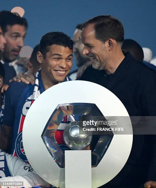 Paris Saint-Germain's Brazilian defender Thiago Silva jokes with Paris Saint-Germain's German head coach Thomas Tuchel in front of the French L1...