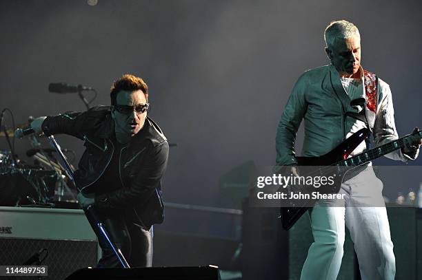 Bono and Adam Clayton perform during the U2 360 Tour at INVESCO Field at Mile High on May 21, 2011 in Denver, Colorado.