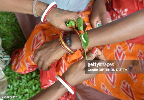 Indian brides and grooms from the Adivasi tribe take part in a mass marriage ceremony in Salbari village on the outskirts of Siliguri on May 19, 2019.