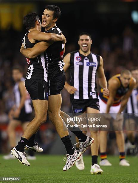 Chris Tarrant of the Magpies is congratulated by team-mates after kicking a goal during the round nine AFL match between the Collingwood Magpies and...