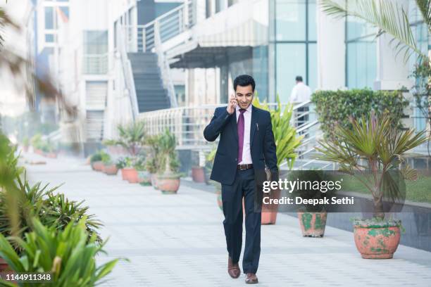 businessman - stock images - man walking out of office building stock pictures, royalty-free photos & images