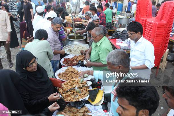 Mumbra area residents and locals flood the markets before iftari prayers, on May 18, 2019 in Mumbai, India. They buy interesting street food items to...