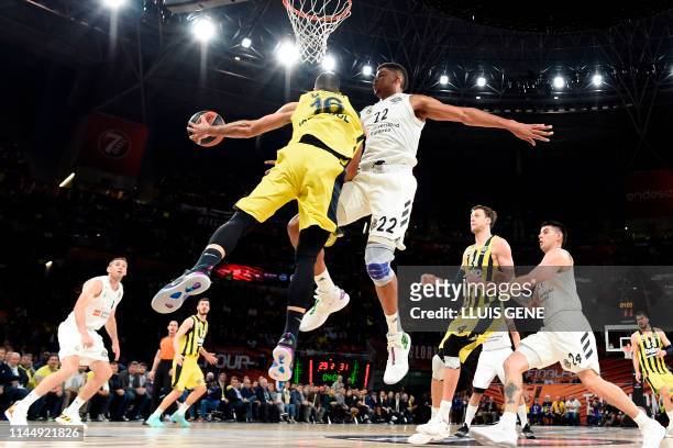Real Madrid's Cape Verdean centre Walter Tavares challenges Fenerbahce's Greek guard Kostas Sloukas during the EuroLeague third place play-off...
