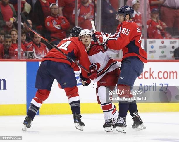 Brooks Orpik and Andre Burakovsky of the Washington Capitals combine to stop Sebastian Aho of the Carolina Hurricanes during the second overtime in...