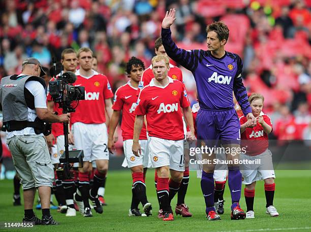 Captain Edwin van der Sar of Manchester United leads out the team for his final league match prior to the Barclays Premier League match between...