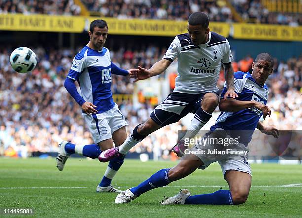 Aaron Lennon of Tottenham Hotspur is challenged by Curtis Davies of Birmingham City during the Barclays Premier League match between Tottenham...