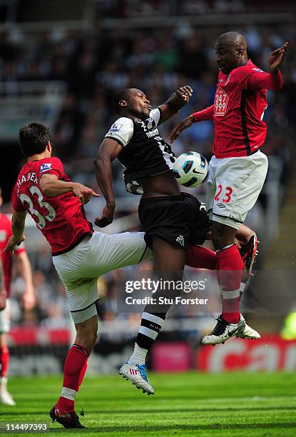 Newcastle player Shola Ameobi is challenged by Paul Scharner and Abdoulaye Meite during the Barclays Premier League game between Newcastle United and...