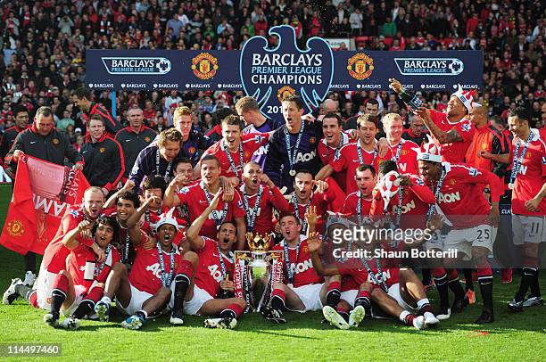 Manchester United celebrate with the Premier League trophy after the Barclays Premier League match between Manchester United and Blackpool at Old...