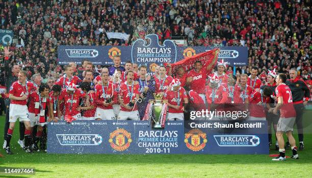 Manchester United celebrate with the Premier League trophy after the Barclays Premier League match between Manchester United and Blackpool at Old...