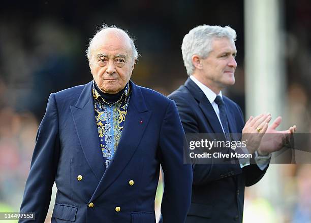 Mohammed Al Fayed and Mark Hughes of Fulham waves on the pitch after the Barclays Premier League match between Fulham and Arsenal at Craven Cottage...