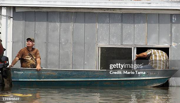 Everett Rodgers and his brother Wayne attempt to retrieve belongings from Everett's flooded home along the Yazoo River near Yazoo City May 22, 2011...