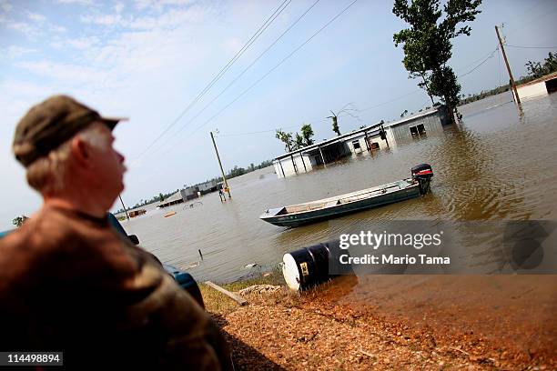 Wayne Rodgers looks toward his brother Everett's flooded home along the Yazoo River near Yazoo City May 22, 2011 in Yazoo County, Mississippi. The...