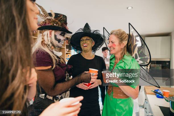 socialising in the kitchen - halloween party stock pictures, royalty-free photos & images