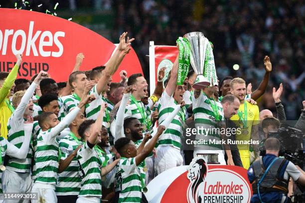 Celtic players celebrate as club captain Scott Brown lifts the trophy during the Ladbrokes Scottish Premiership match between Celtic FC and Heart of...