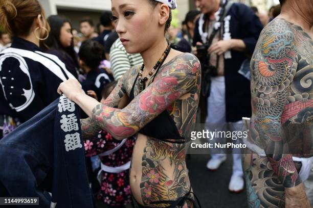 Participants with Japanese tattoos were seen in the street of Asakusa during Sanja Festival on May 19, 2019 in Tokyo, Japan. A boisterous traditional...
