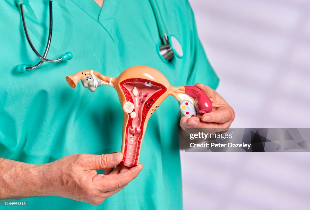 Surgeon in scrubs discussing common pathologies