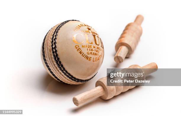 white night-time leather cricket ball and bails - cricket ball stock pictures, royalty-free photos & images