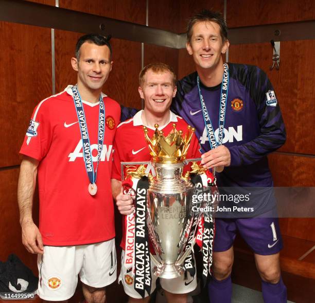 Edwin van der Sar, Ryan Giggs and Paul Scholes of Manchester United poses in the dressing room with the Barclays Premier League trophy after the...