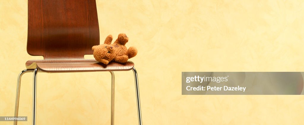 Teddy bear left abandoned on chair