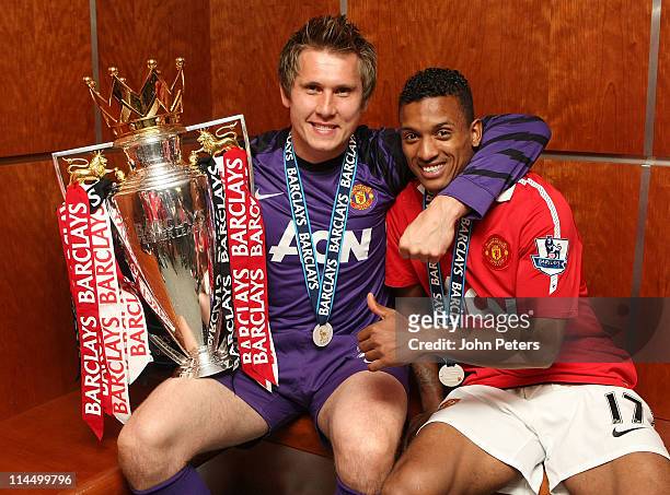 Tomasz Kuszczak and Nani of Manchester United poses in the dressing room with the Barclays Premier League trophy after the Barclays Premier League...