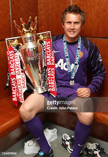 Tomasz Kuszczak of Manchester United poses in the dressing room with the Barclays Premier League trophy after the Barclays Premier League match...