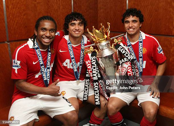 Anderson, Rafael Da Silva and Fabio Da Silva of Manchester United pose in the dressing room with the Barclays Premier League trophy after the...